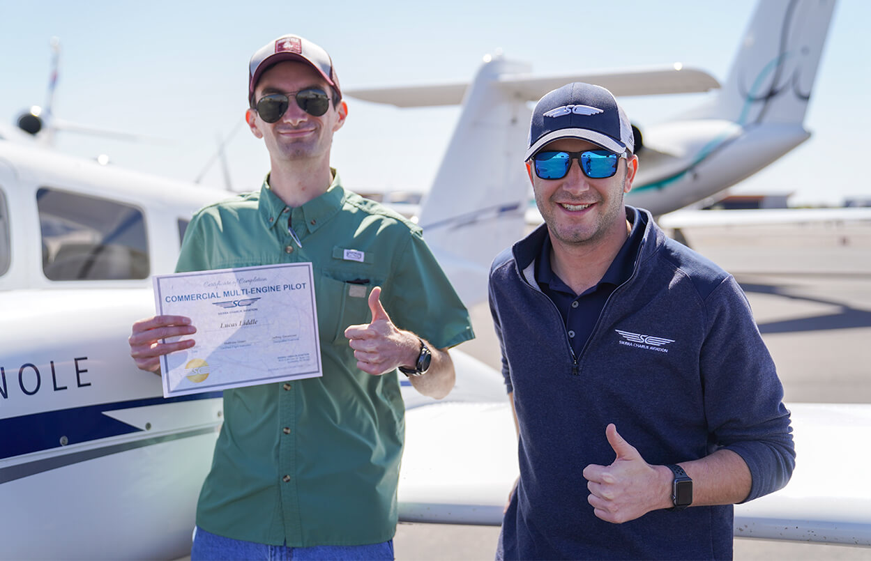 a CFI giving a thumbs up next to an aviation student